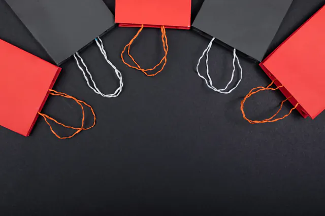 Red and black shopping bags on a dark background