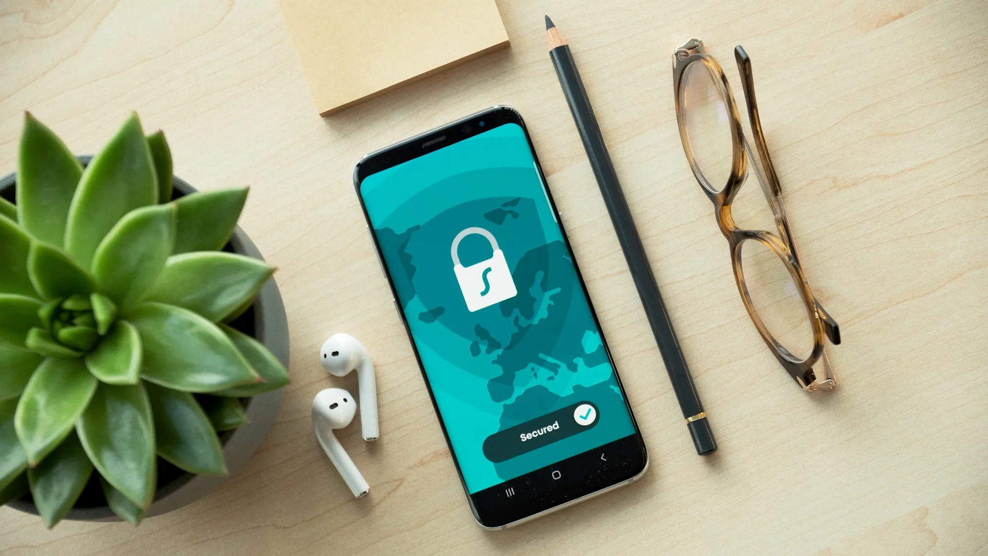 Smartphone showing a padlock privacy screen on a desk